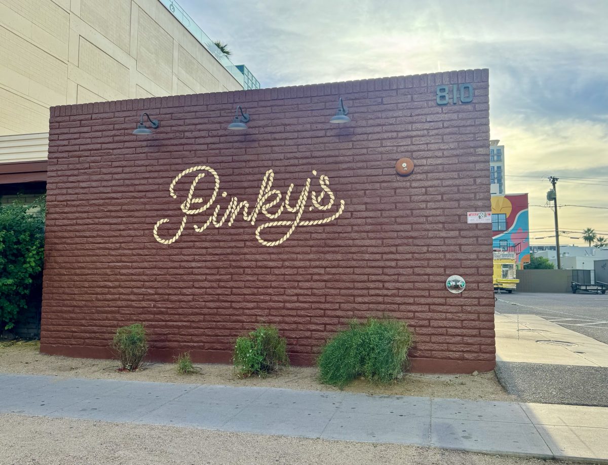 The exterior wall of Pinky's with a rope logo painted on the wall.