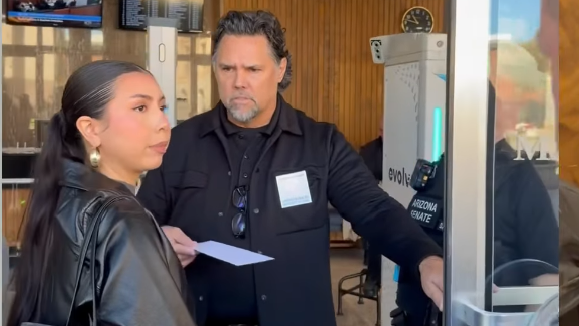 a woman is denied entry by a security officer at the arizona senate