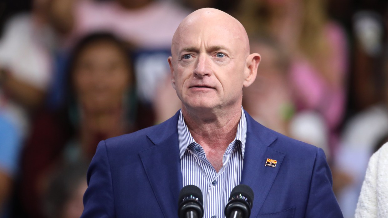 arizona sen. mark kelly in a blue blazer and an arizona flag lapel pin