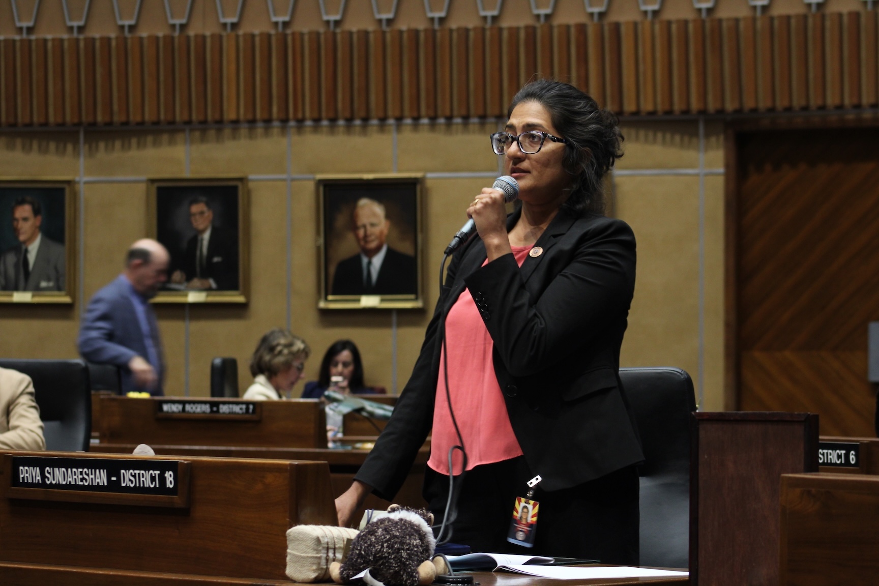 Priya Sundareshan, the Senate Minority Leader, holds a microphone to speak against anti-Muslim laws