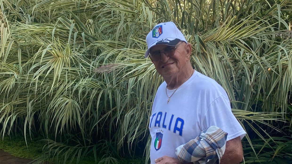 tom garro in a white shirt and hat