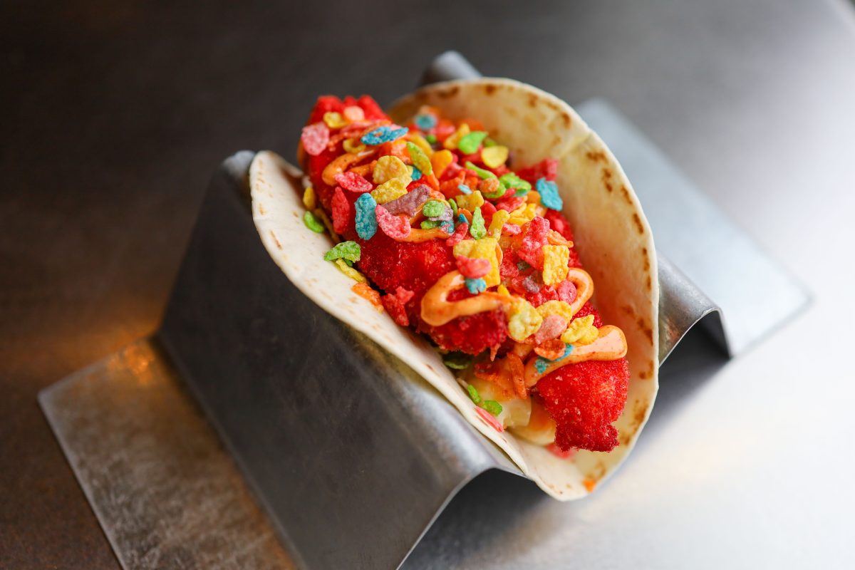 A taco in a metal holder.