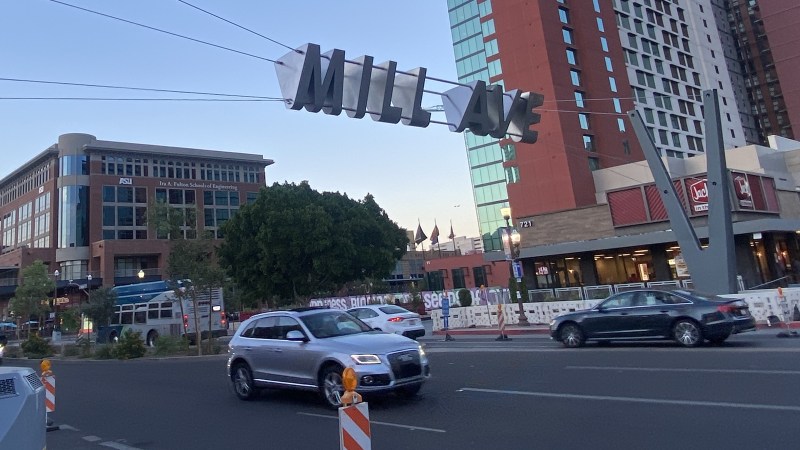 Mill Avenue sign over traffic in downtown Tempe, Arizona