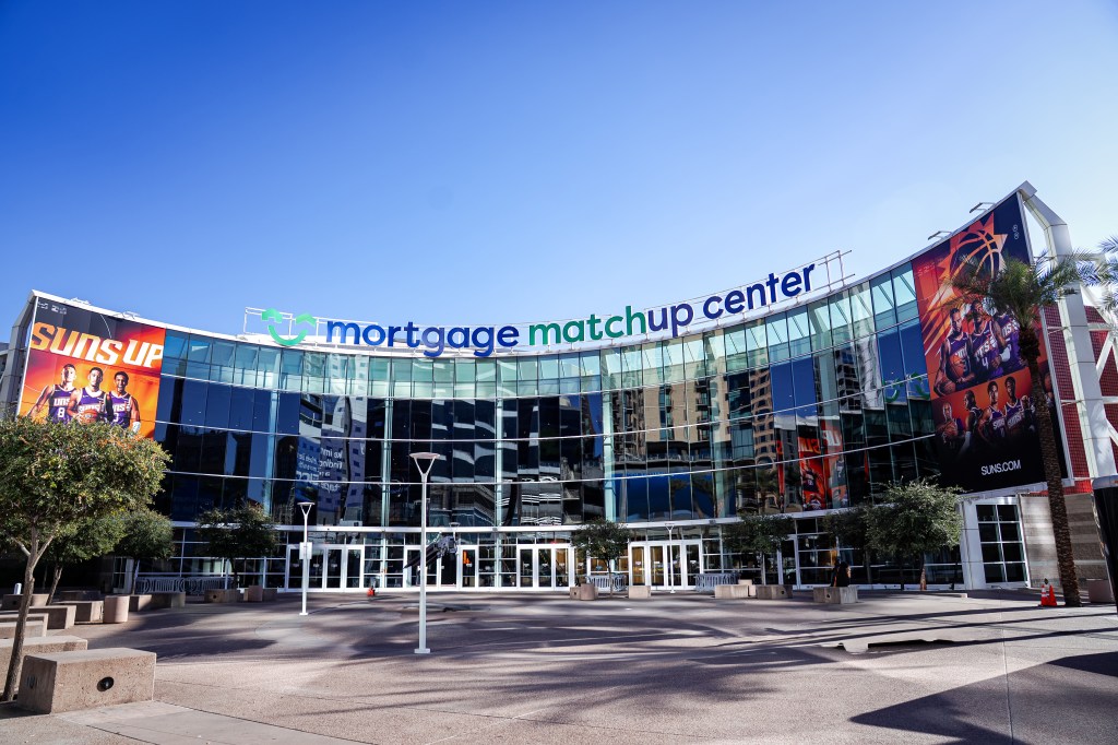 Mortgage Matchup Center in downtown Phoenix during the day, showing the main entrance and plaza outside the arena