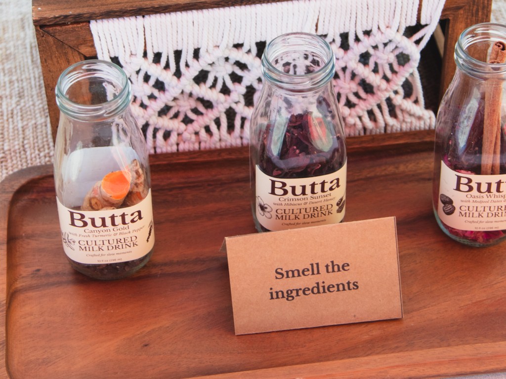 Milk bottles filled with ingredients like tumeric, dried hibiscus and cinnamon sticks.
