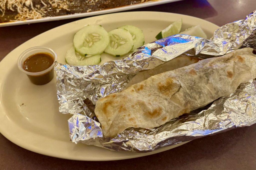 A wrapped Taco Arabe on a plate at El Rincon Poblano.