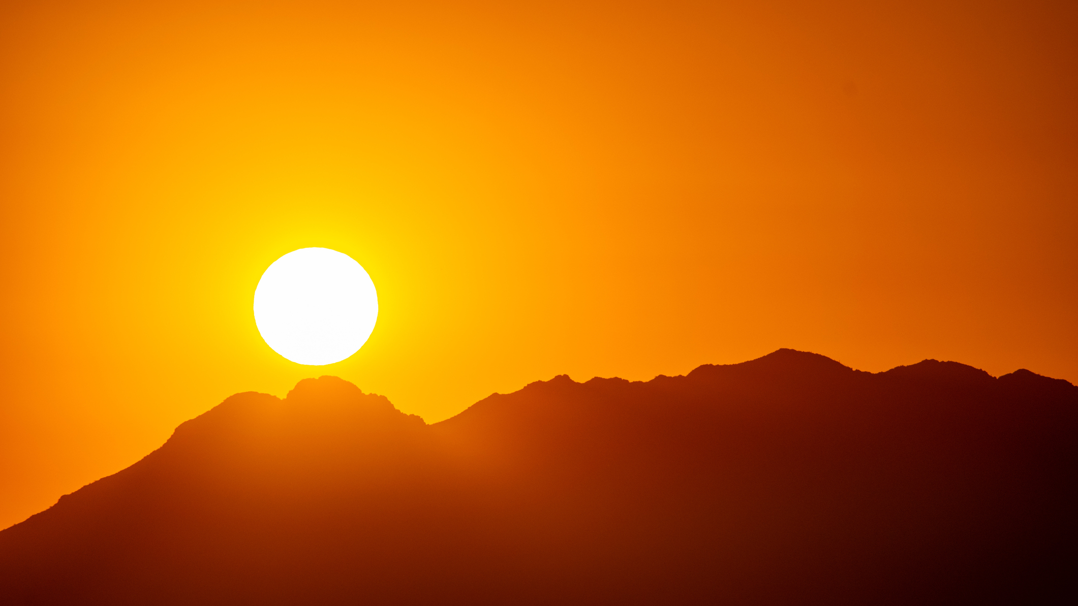a sun rising over a mountain in phoenix