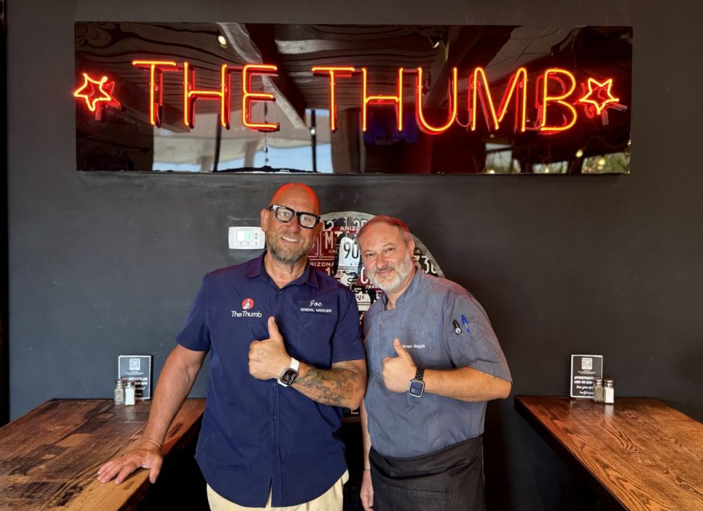The general manager of The Thumb poses with the barbecue joint's chef.