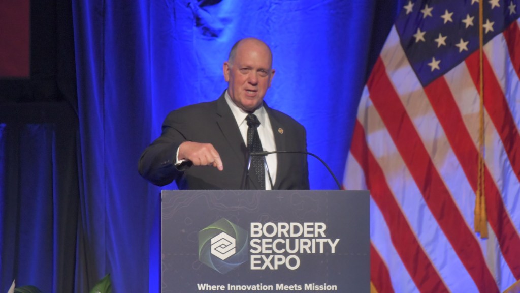 tom homan speaks at a podium at the border security expo