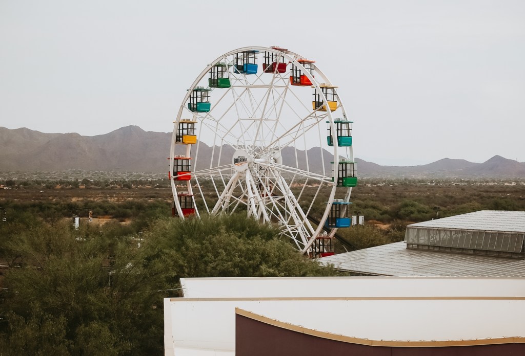 An 80-foot-tall Ferris wheel towers over the Arizona Boardwalk entertainment and shopping complex in Scottsdale.