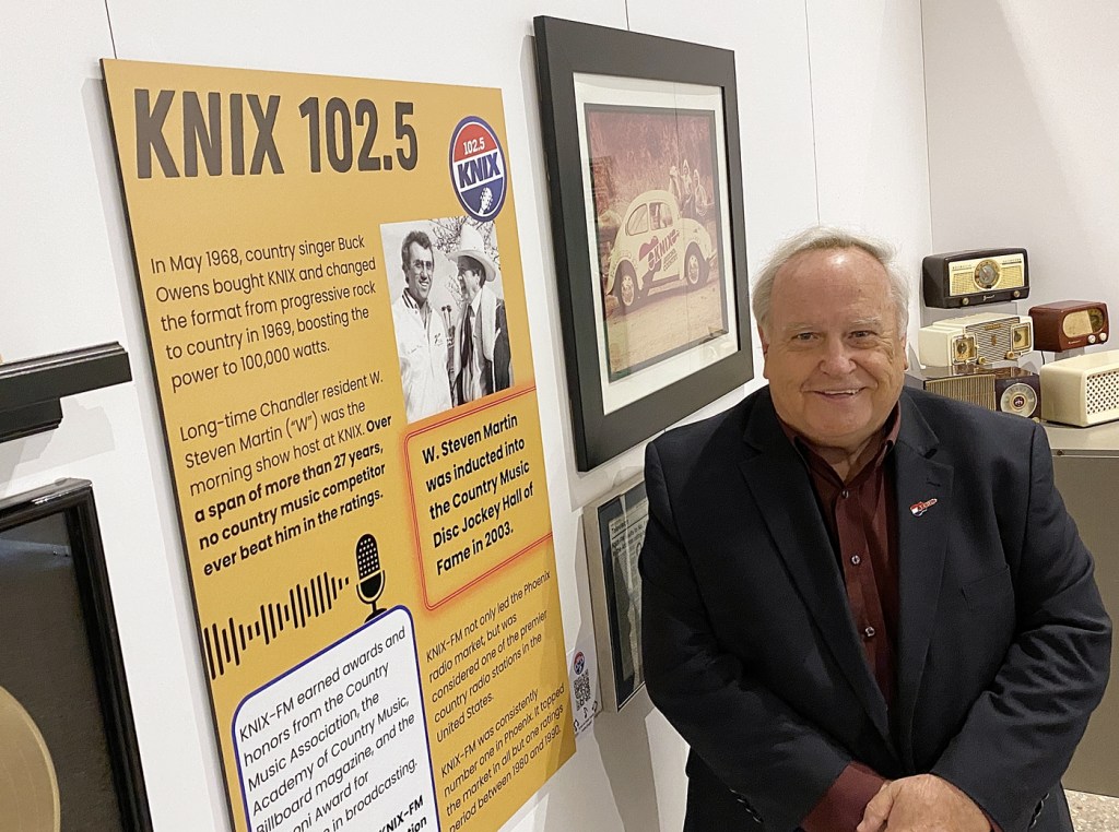 Arizona broadcaster Jim West stands inside the Chandler Museum's exhibit "Radio That Rocked the Valley."