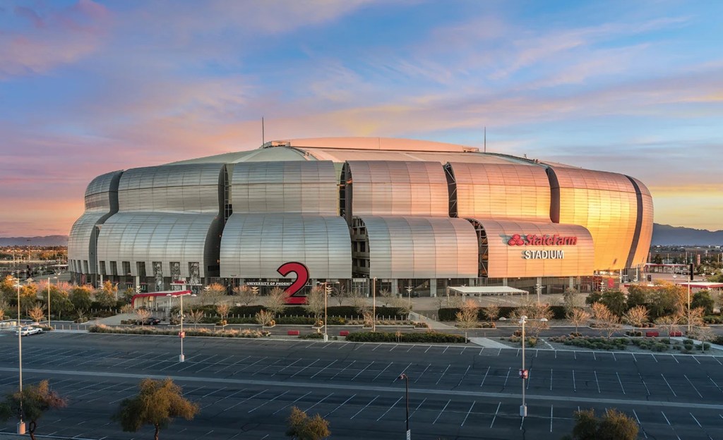 Exterior view of State Farm Stadium in Glendale at sunset.