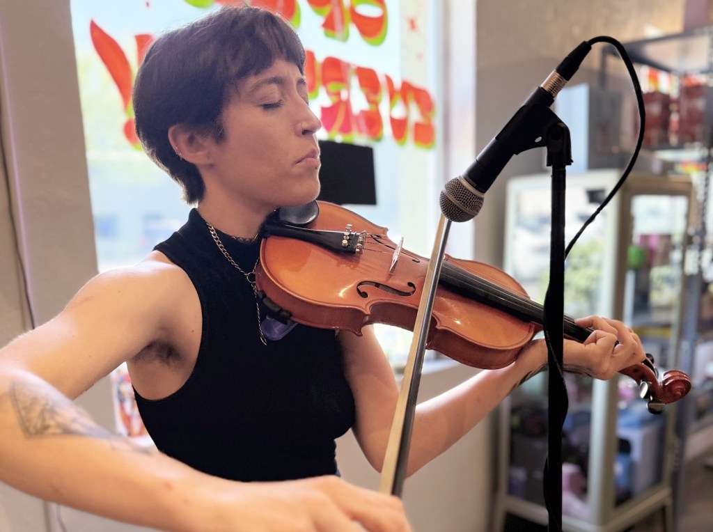 Violinist Lys Wainwright performs during a Make Music Day event at Monsoon Market in Phoenix.