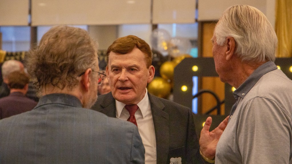 david stringer talks to people at a party