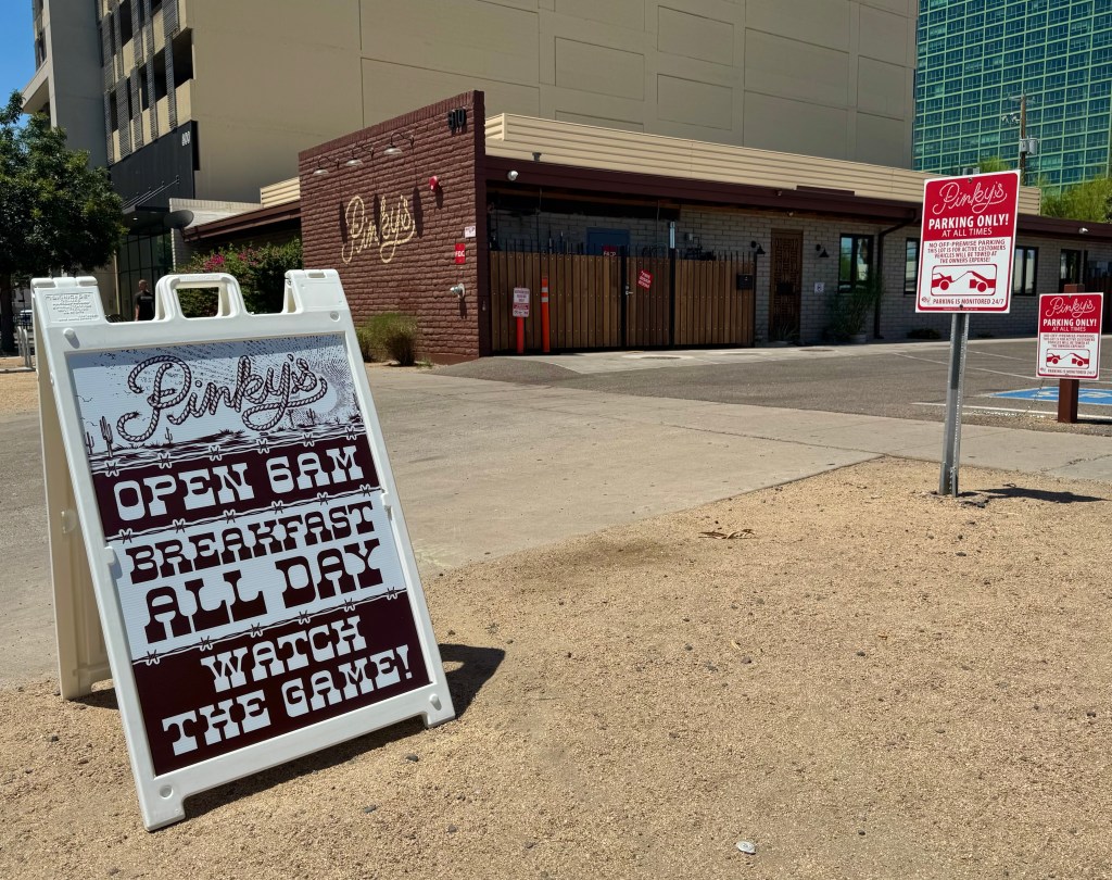 A sandwich board outside Pinky's advertises it opening at 6 a.m. and serving breakfast all day.