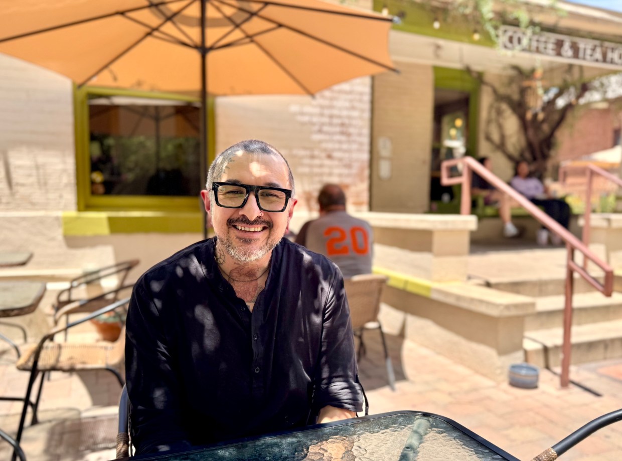 Songbird Coffee & Tea House barista Enzo Rascon sits on the cafe's patio.