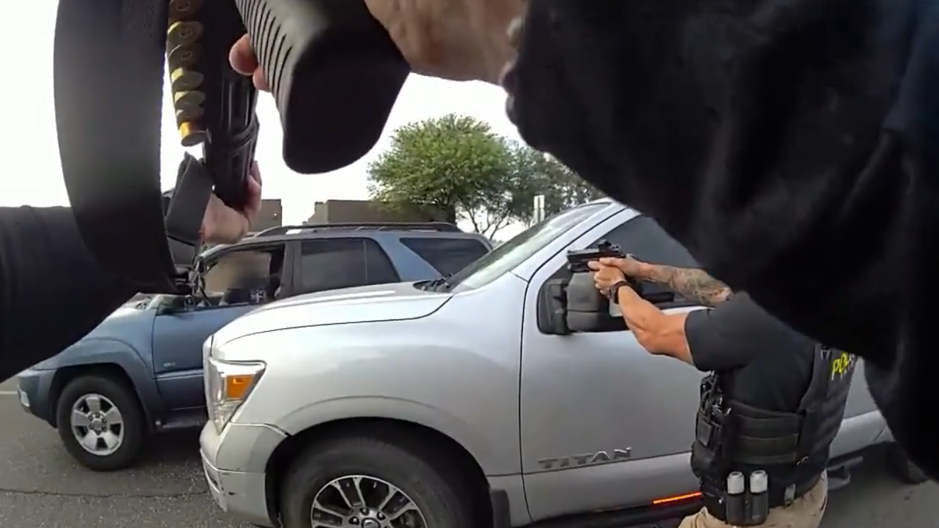 body cam footage showing two phoenix police officers pointing guns at a man in the front seat of an suv