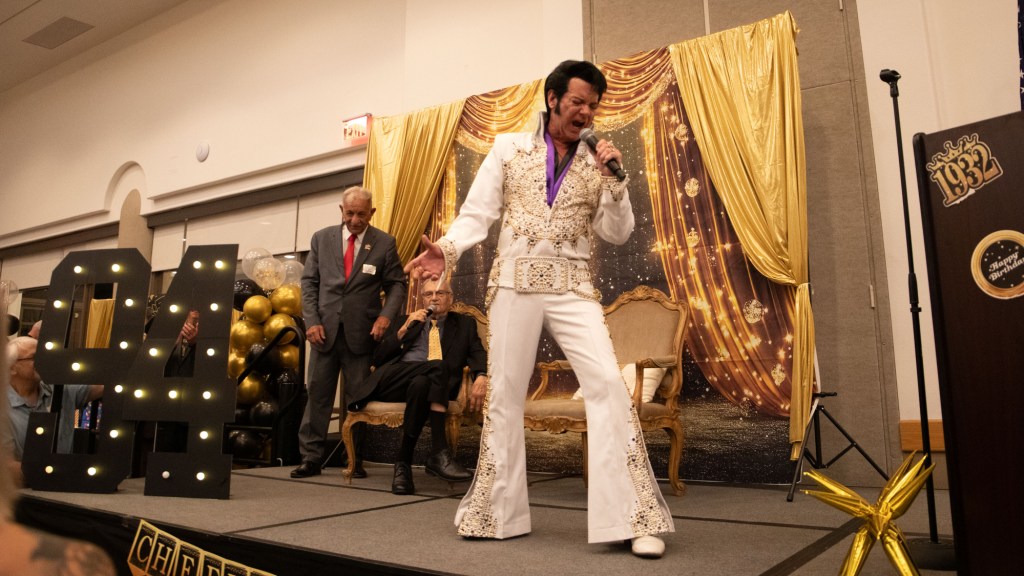 an elvis impersonator performs in front of joe arpaio