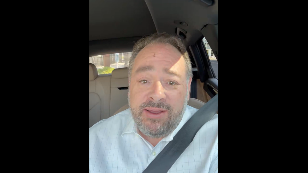 a man filming a selfie video in his car