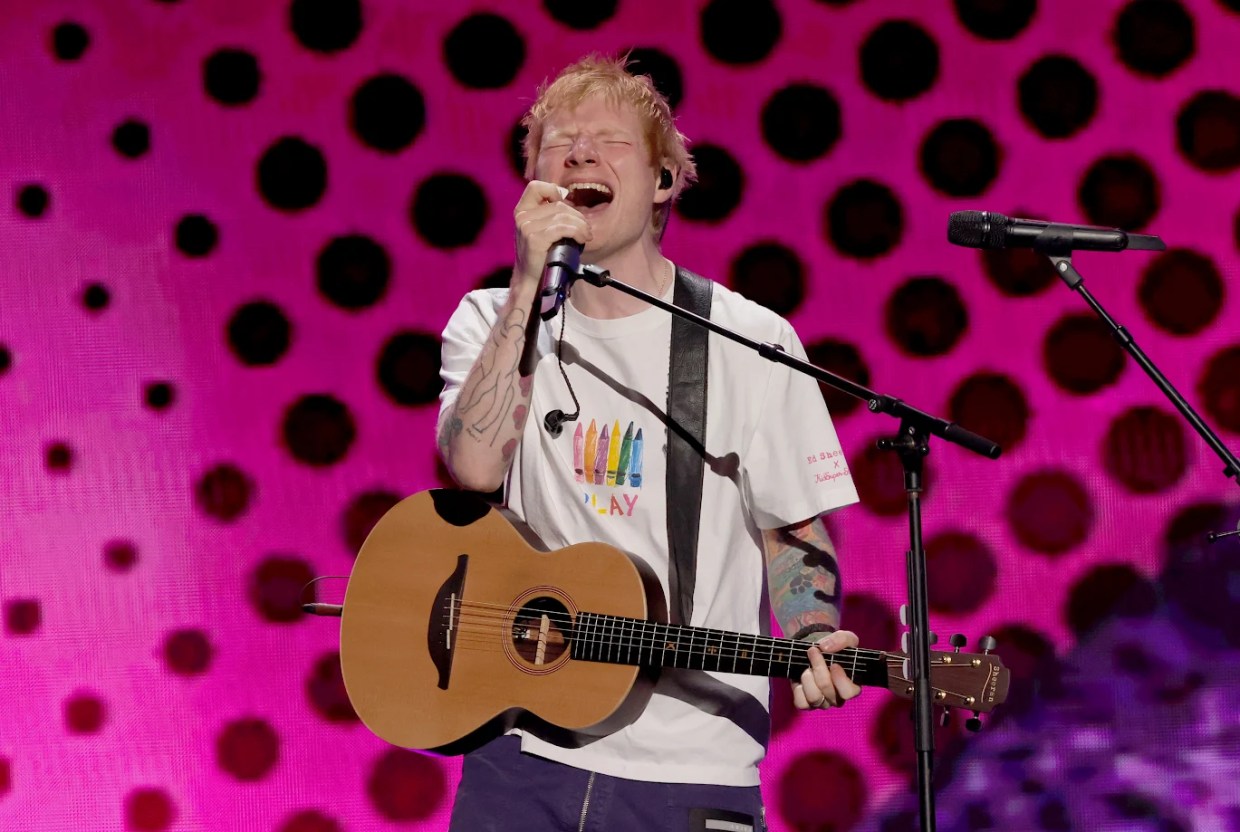 Ed Sheeran performs with an acoustic guitar during the 2025 iHeartRadio Music Festival in Las Vegas ahead of his June 2026 concert at State Farm Stadium in Glendale.