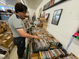 A male shopper looks through CD bins inside The Ghost of Eastside Records.