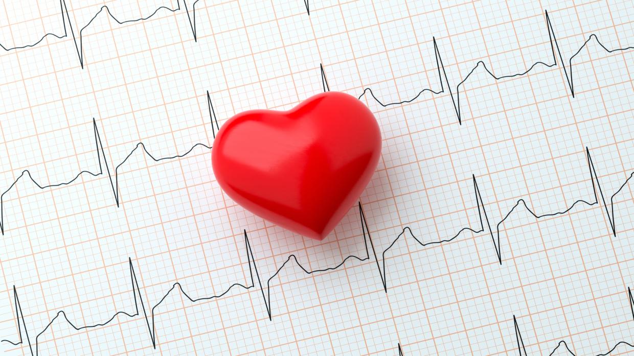 a foam heart over an EKG printout