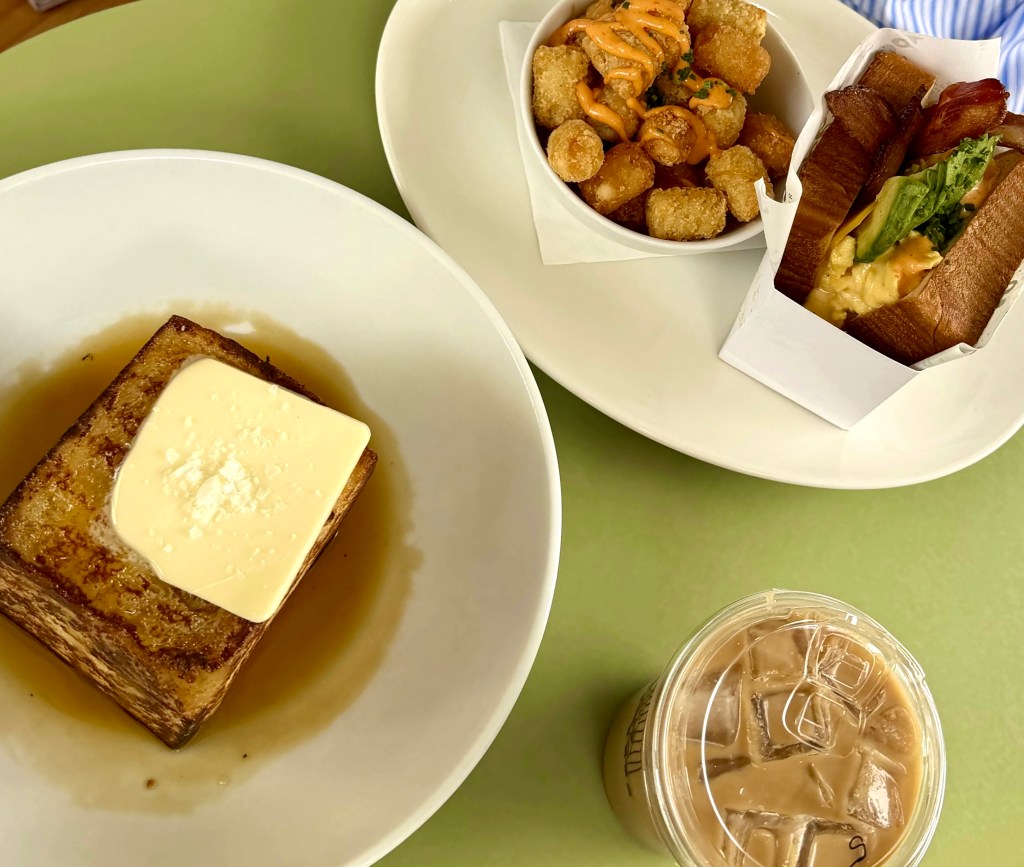 French toast, a breakfast sandwich and iced coffee on a table at Sophia's.