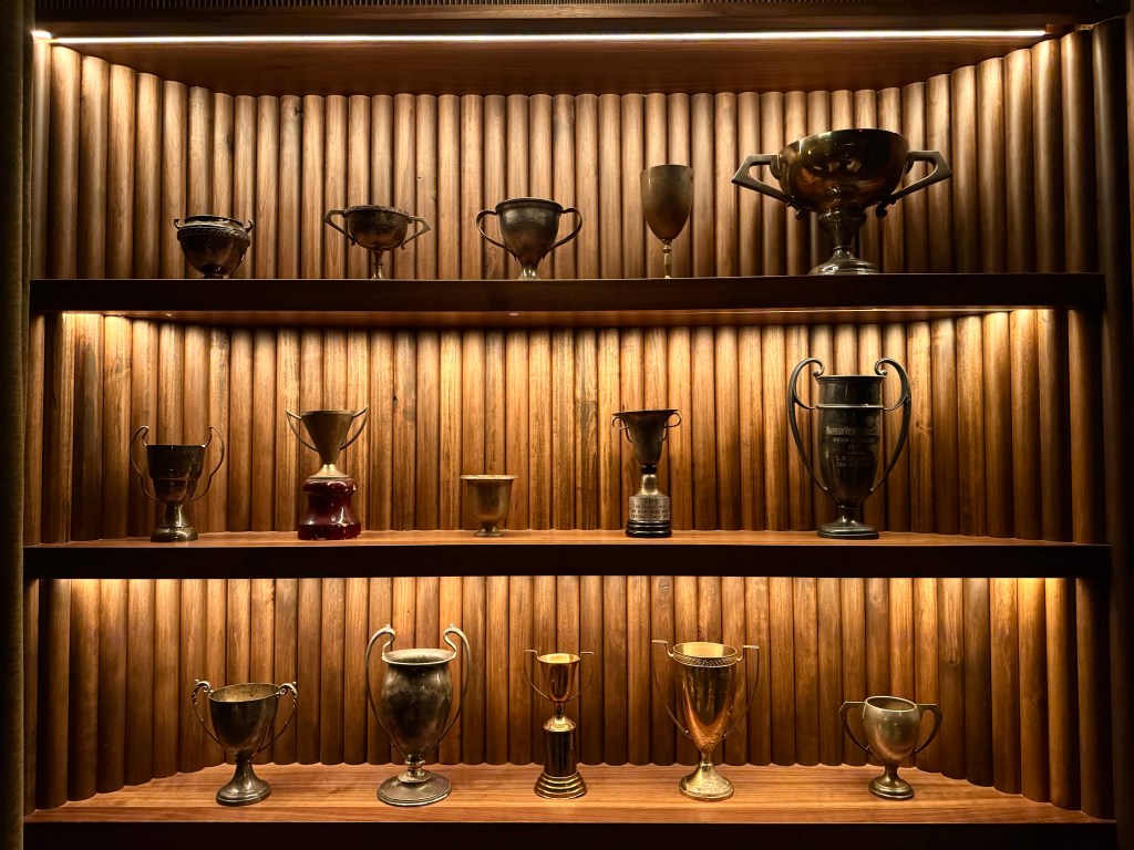 Shelves holding vintage trophies at Trophy Room.