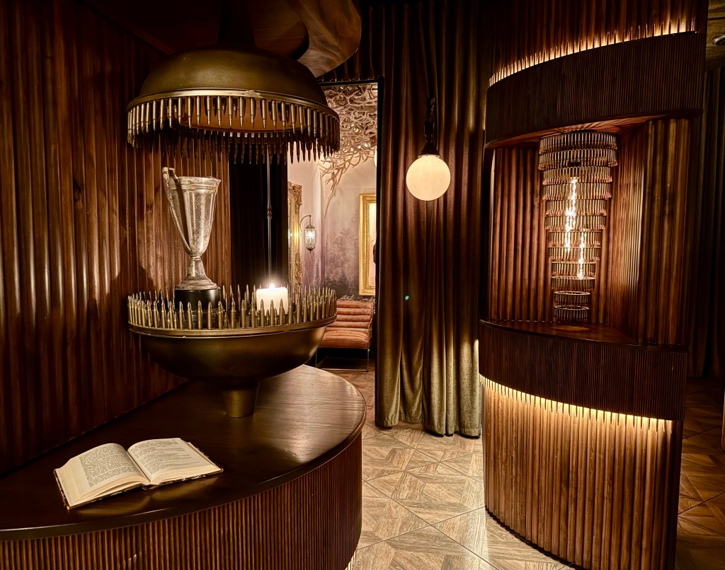 Niches with chandeliers and art made from bullets at Trophy Room.