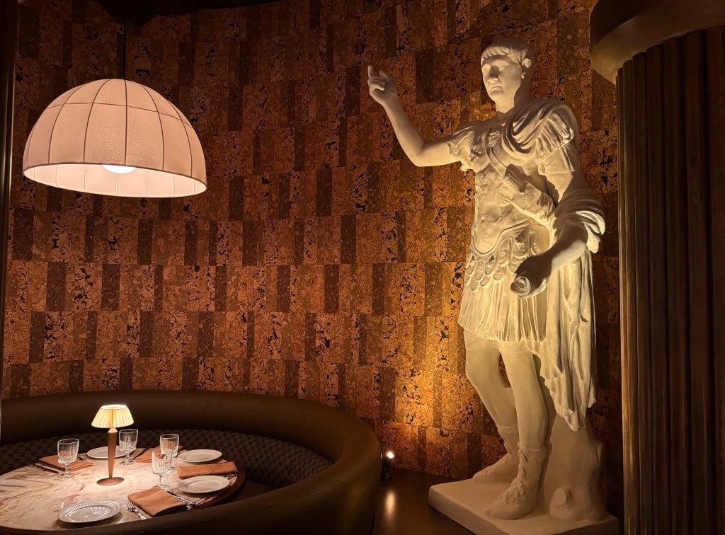 A sculpture over a booth at Roman God of Fire.