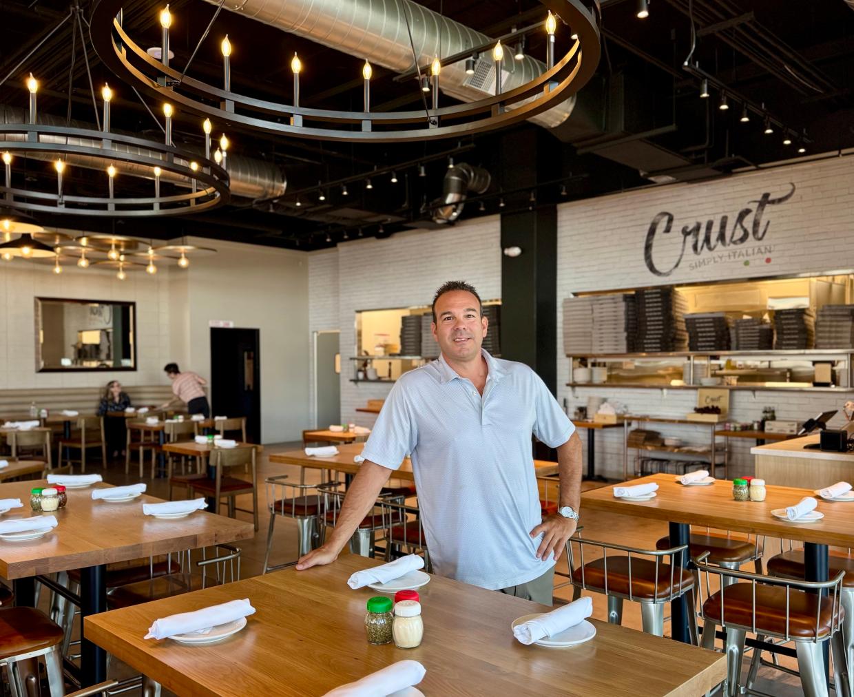 Crust Concepts owner Michael Merendino stands inside the dining room of the Mesa location of Crust Simply Italian.