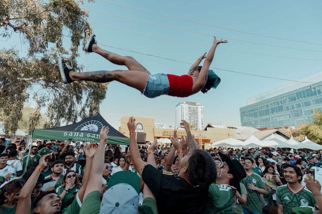 A woman is thrown in the air in celebration during a World Cup watch party at Sana Sana Cerveceria.