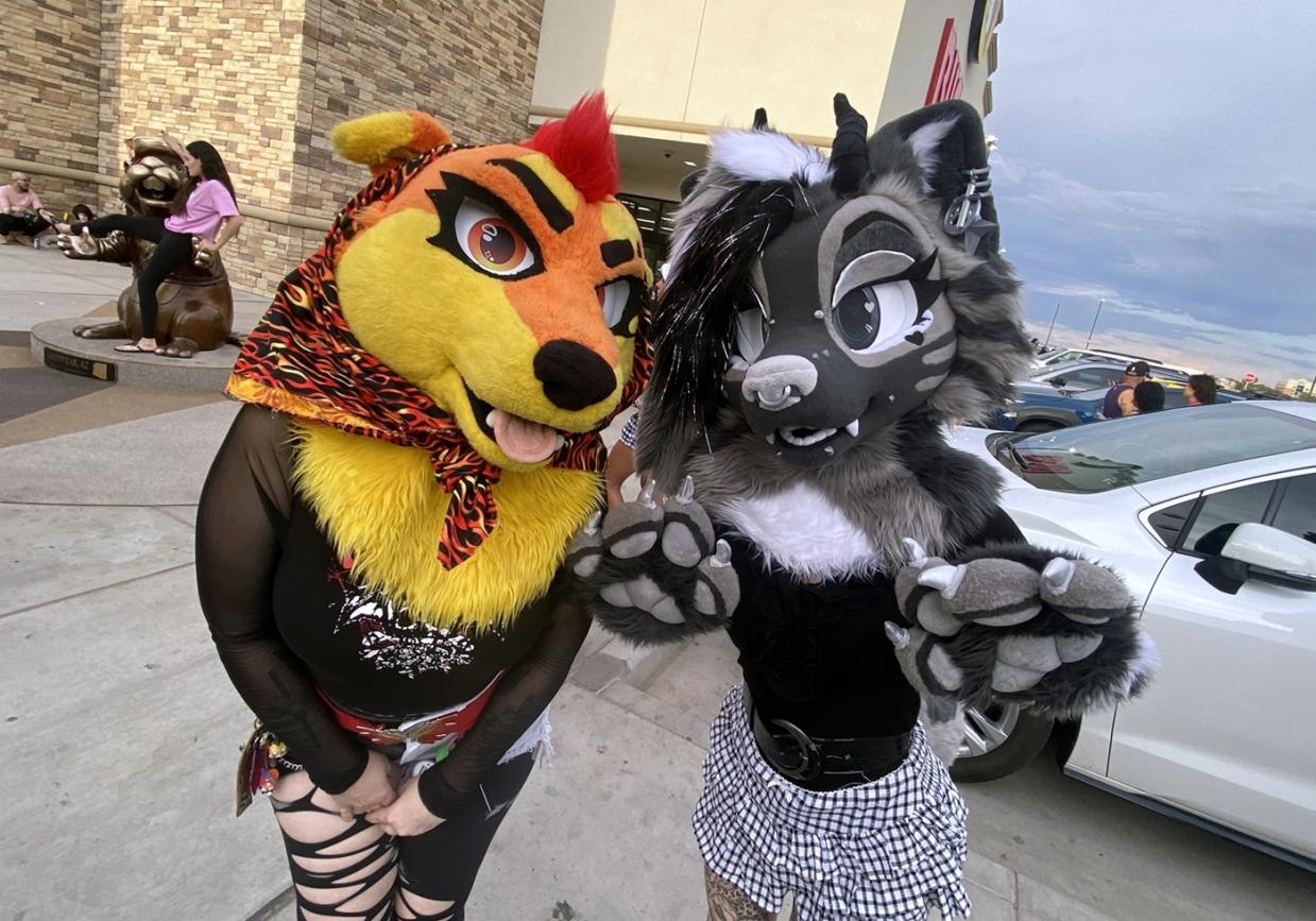 Arizona fursuiters Moxie Claws and Helios pose outside Buc-ee’s in Goodyear during a July 25 furmeet.