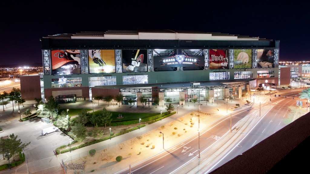 Chase Field is illuminated at night in downtown Phoenix. The stadium hosts Arizona Diamondbacks games, concerts and other major events.