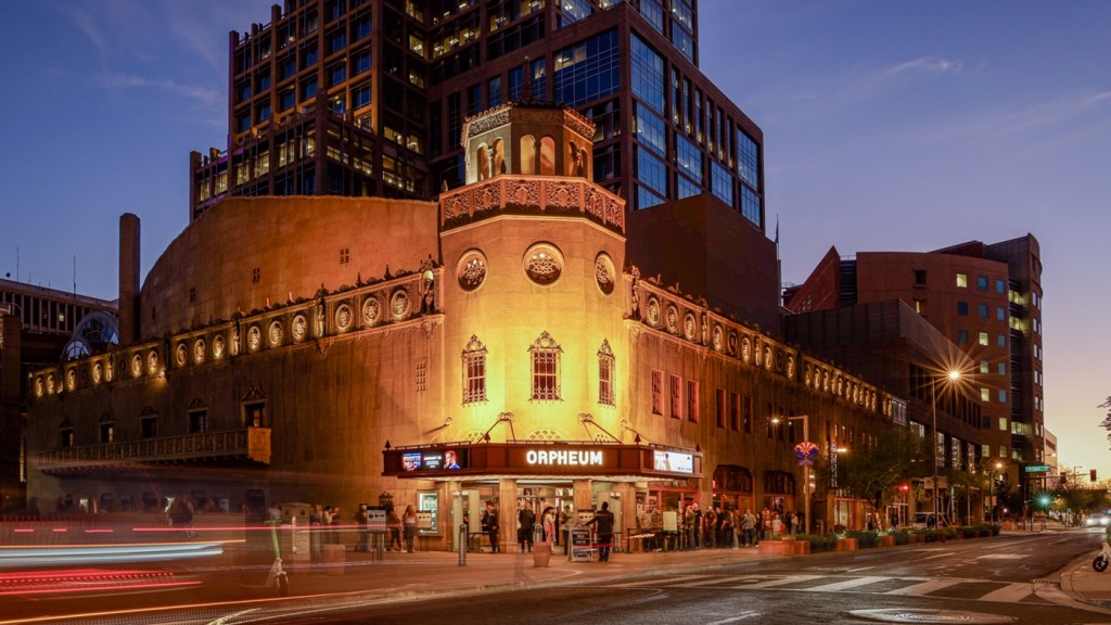 The exterior of the historic Orpheum Theatre in downtown Phoenix illuminated at dusk.