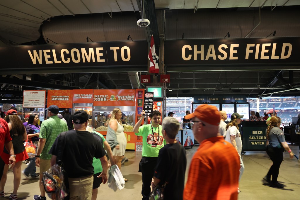 Fans walk past the Cactus Corn kiosk on the concourse at Chase Field.