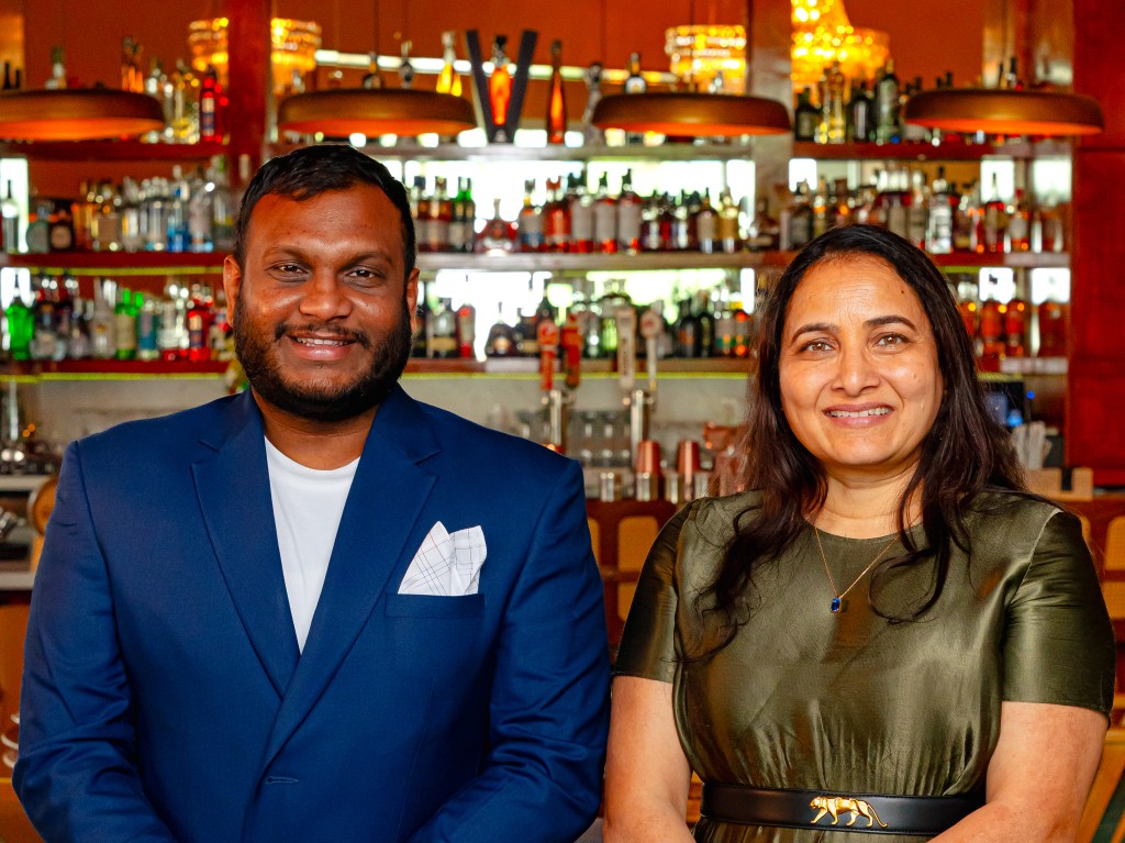 Nadu general manager Kishore Thadikamalla and Reddy pose in front of the restaurant's bar.