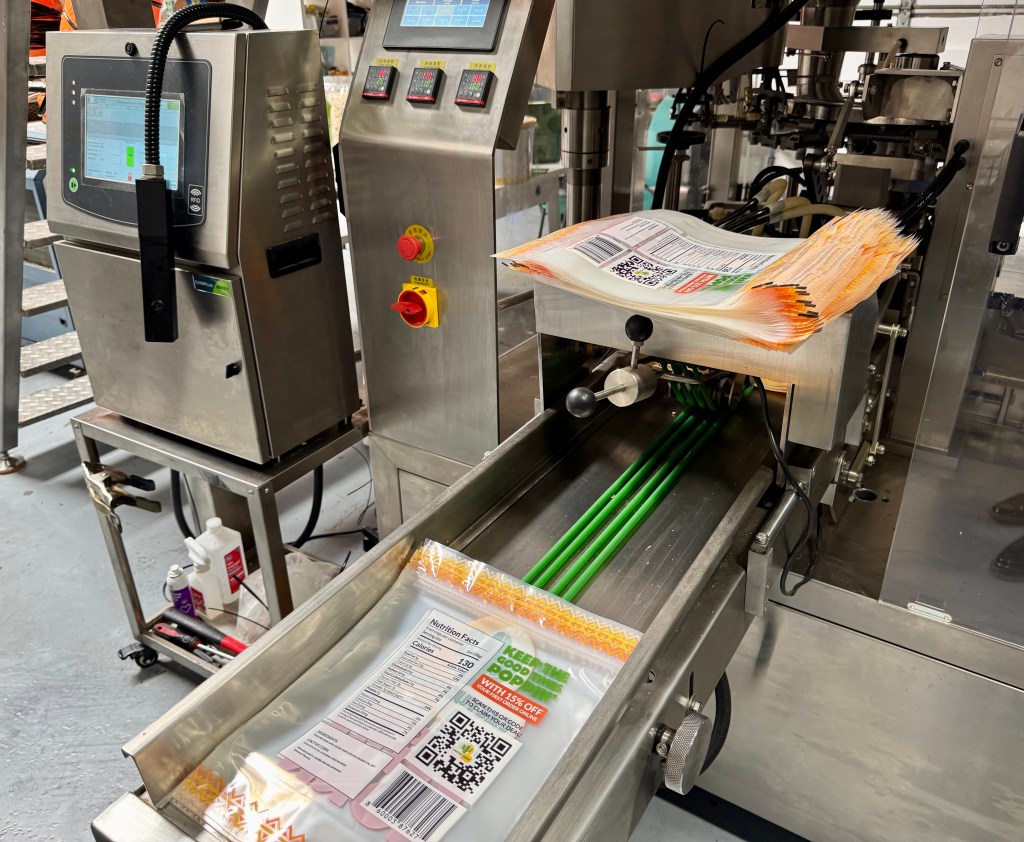 Bags wait to be fed into a packaging machine at Cactus Corn.