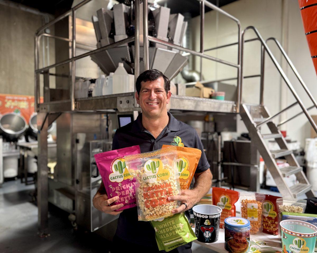 Cactus Corn owner Chris Levandowski poses with bags of the popcorn in the company's production facility.