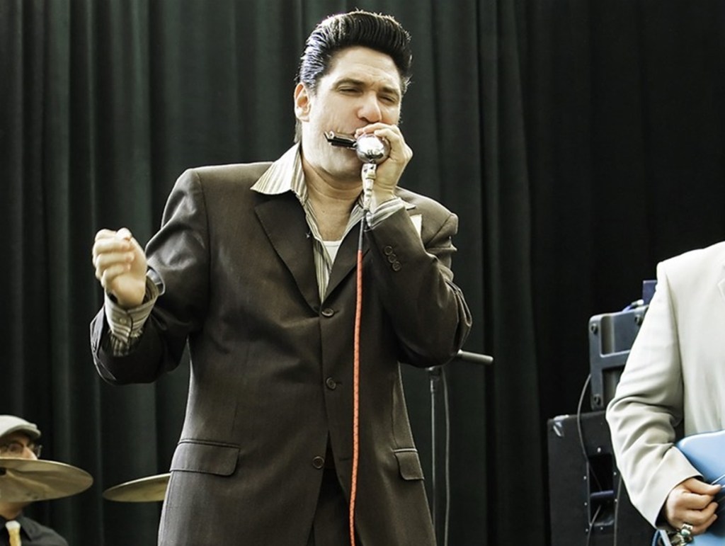 Bob Corritore plays harmonica during a live performance.