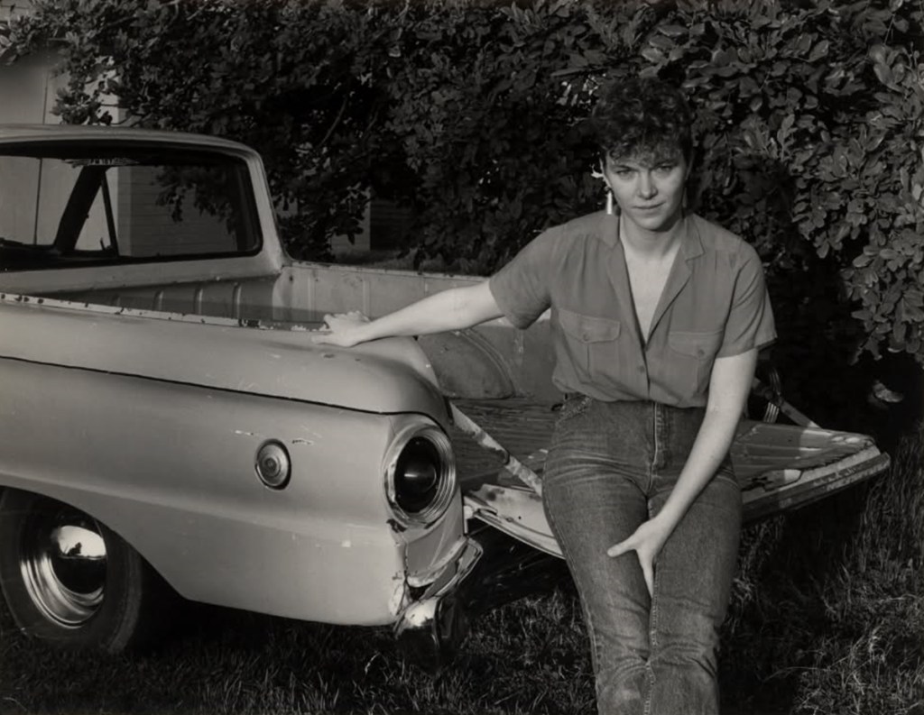 Mary McCann sits on the back of a 1963 Ford Falcon Ranchero in an undated black-and-white photo.