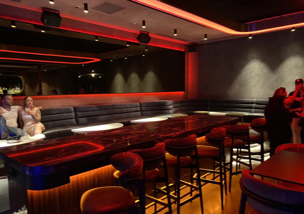 Lounge seating, tables and red lighting inside Roosevelt in downtown Phoenix.