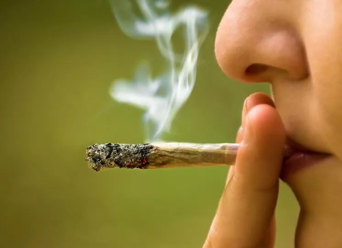 a person smoking a blunt