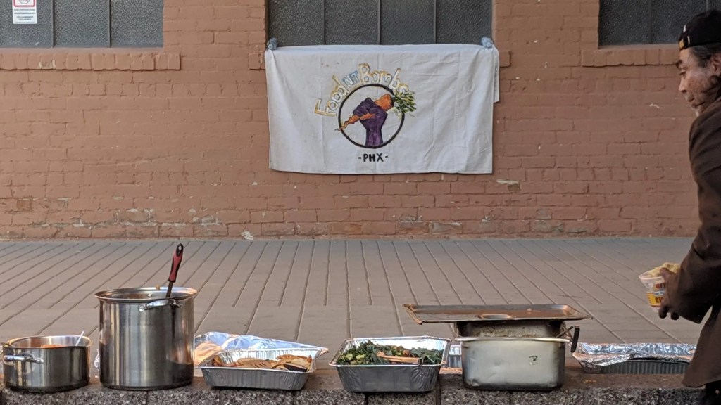 a table set up with food by food not bombs phoenix
