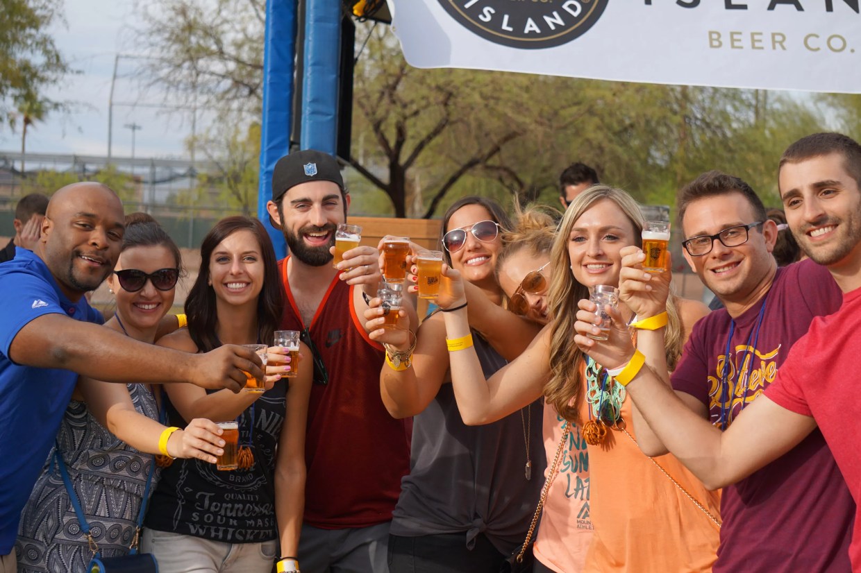 Friends cheers at the Strong Beer Festival.