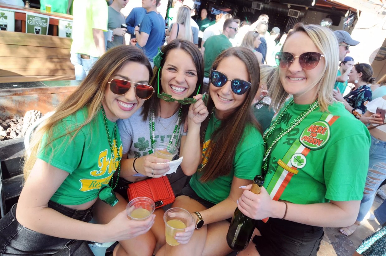 Young women celebrating at a bar.