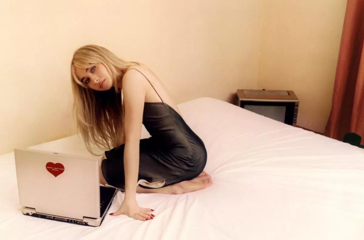 A woman sitting on a bed.
