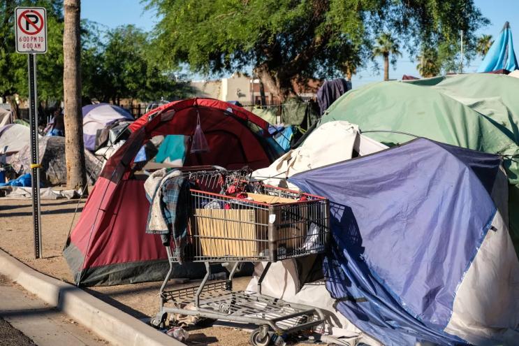 Possessions of a Zone resident fill a shopping cart