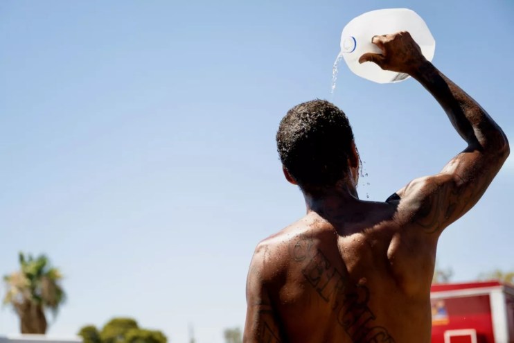 Man pours water on his head.