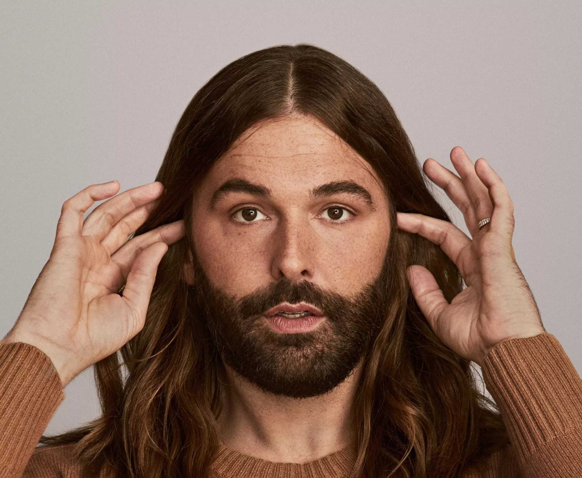 Jonathan Van Ness in a brown shirt